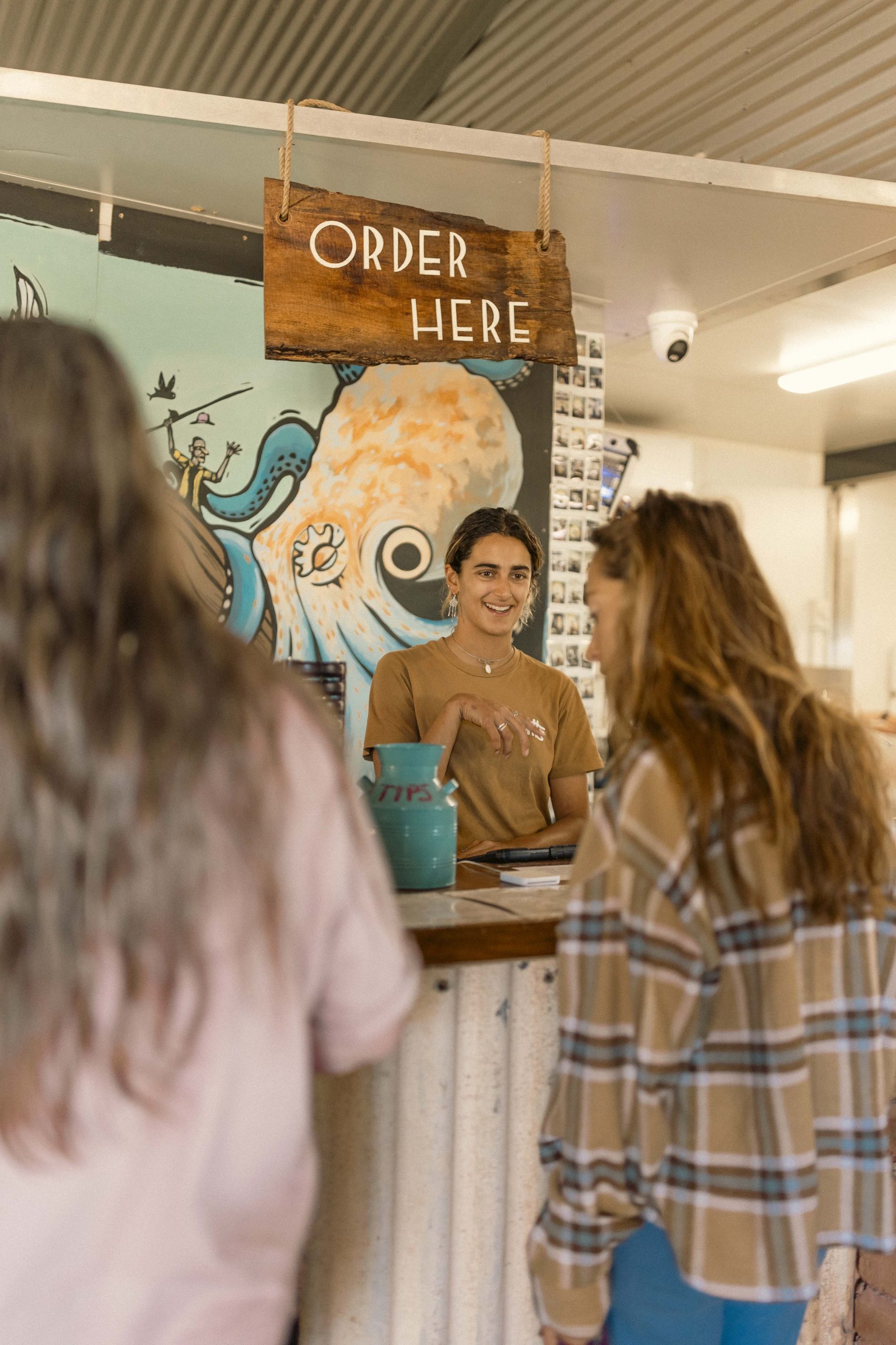 Order Here at Mutts Café Exmouth Staff taking orders under the order here sign at Mutts Café Exmouth front counter. Hospitality jobs Exmouth WA