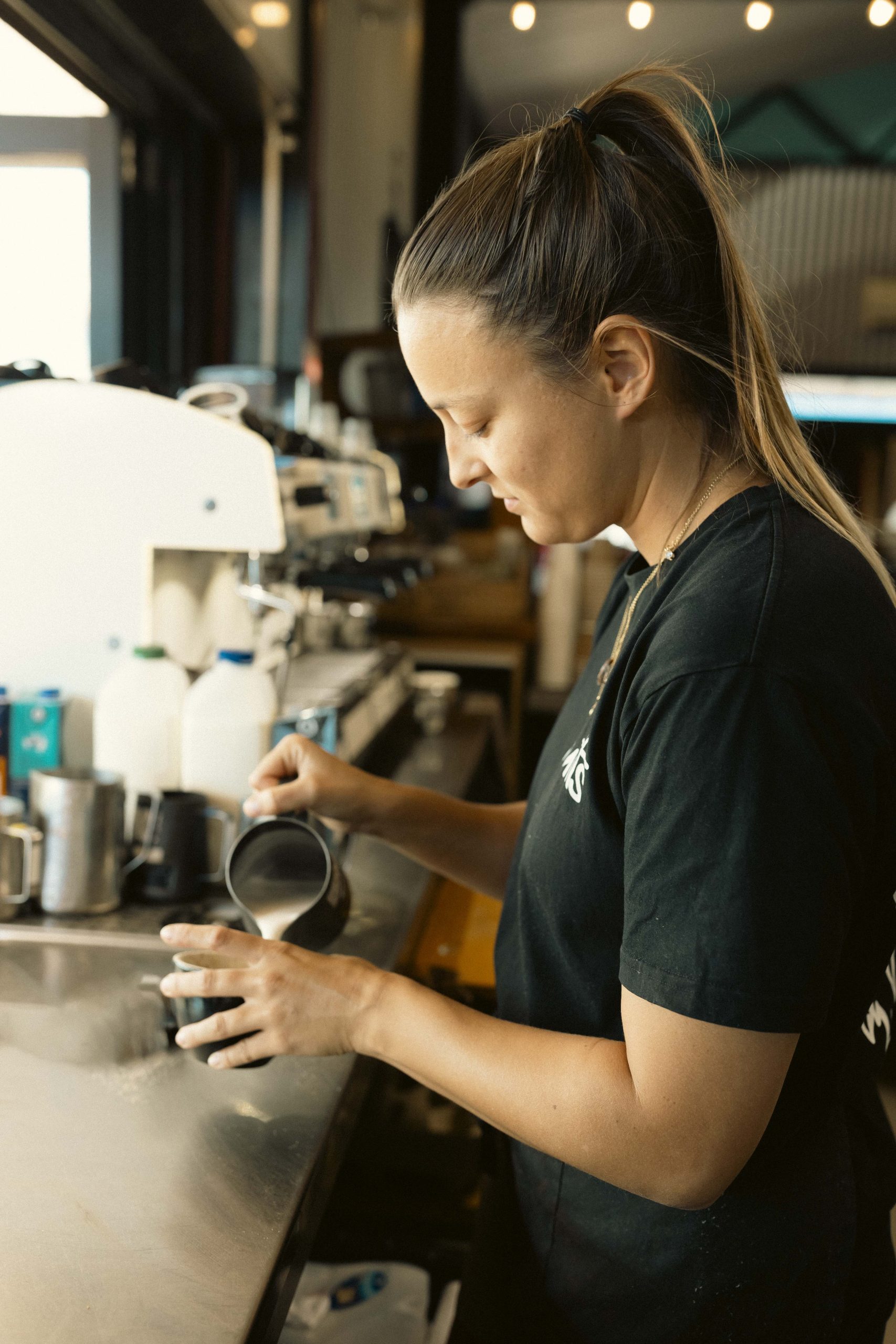 Barista-Quality Coffee at Mutts Café Exmouth Barista pouring fresh coffee ready to serve at Mutts Café Exmouth. Hospitality jobs Exmouth WA