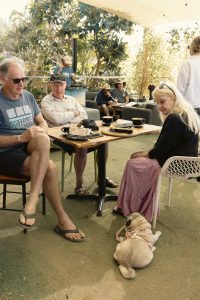 Relaxed Lunch with Friends | Mutts Café Exmouth Group of older friends enjoying lunch and coffee with their dog outside at Mutts Café Exmouth